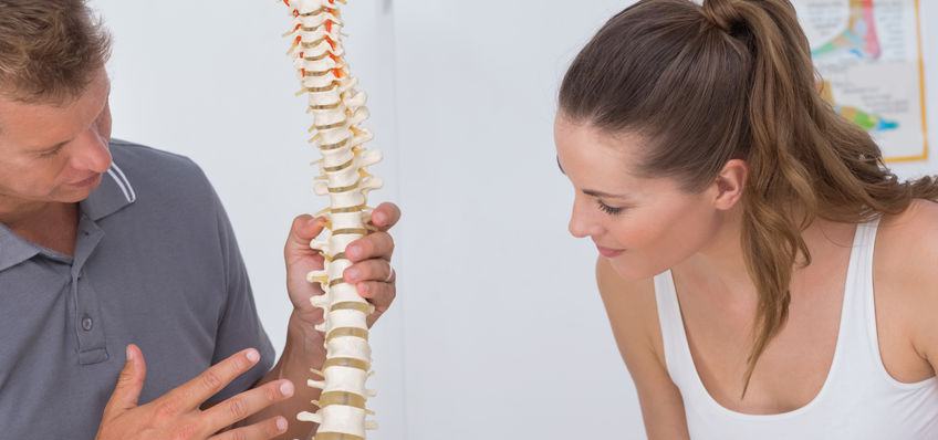 image of a doctor explaining a spinal treatment, osteopath chiropractor